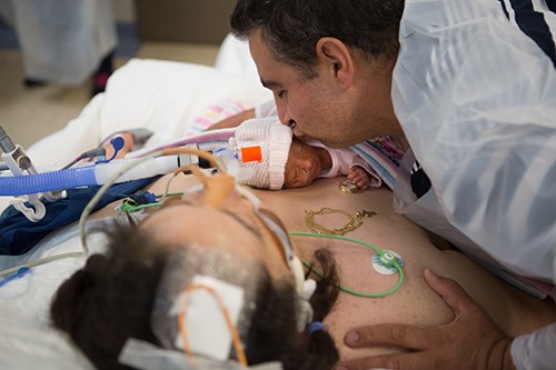 Joanna in a coma with her daughter on her chest